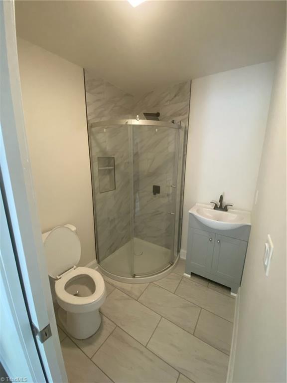 820 Broad Ave, Greensboro, NC 27406 - bathroom featuring toilet, a shower stall, and vanity
