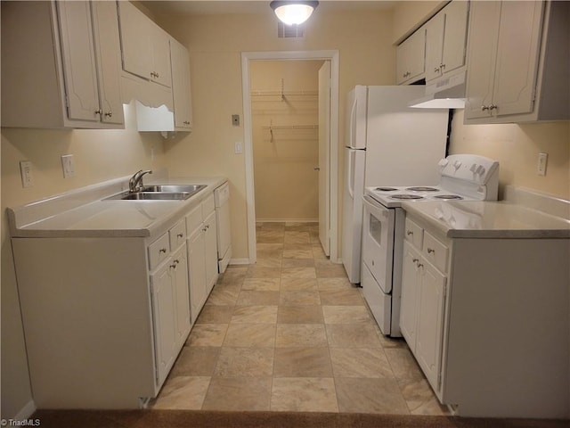 kitchen with white cabinets, a sink, white appliances, light countertops, and under cabinet range hood