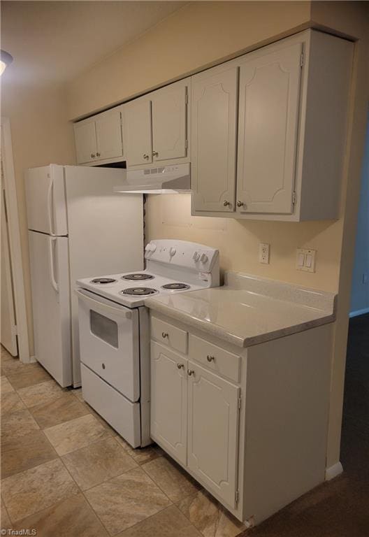 kitchen featuring white appliances, stone finish floor, light countertops, under cabinet range hood, and white cabinets