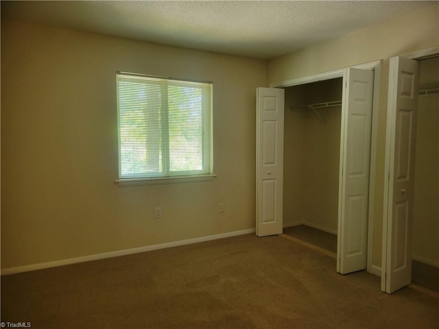unfurnished bedroom featuring baseboards and carpet