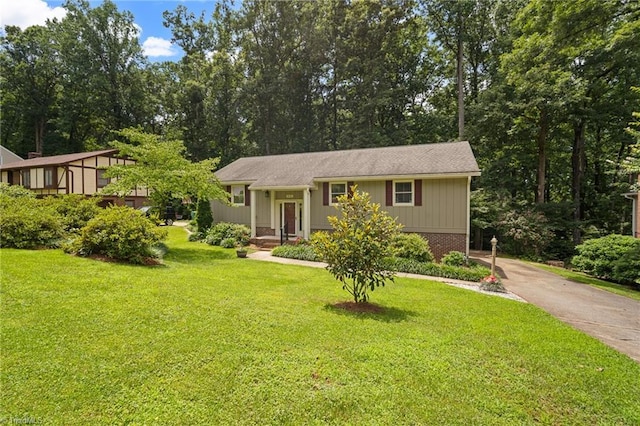515 Dogwood Ct, High Point, NC 27260 - view of front of home with a front yard, driveway, and view of scattered trees
