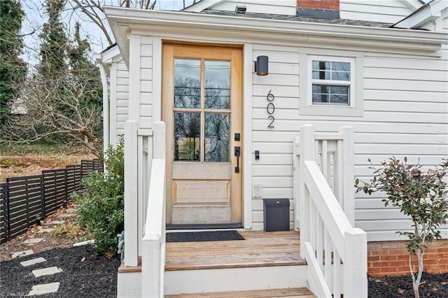 entrance to property featuring fence