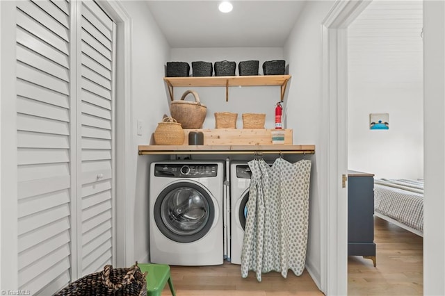 laundry room featuring laundry area, washer and clothes dryer, wood finished floors, and recessed lighting