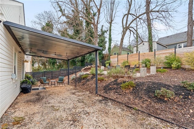 view of yard featuring fence and a patio