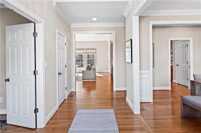 corridor featuring crown molding and hardwood / wood-style flooring