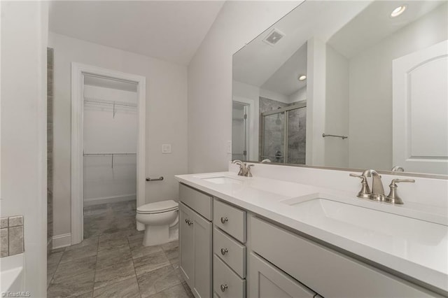 bathroom featuring toilet, vanity, lofted ceiling, and walk in shower