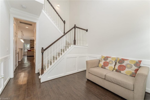 living room with dark hardwood / wood-style flooring and crown molding