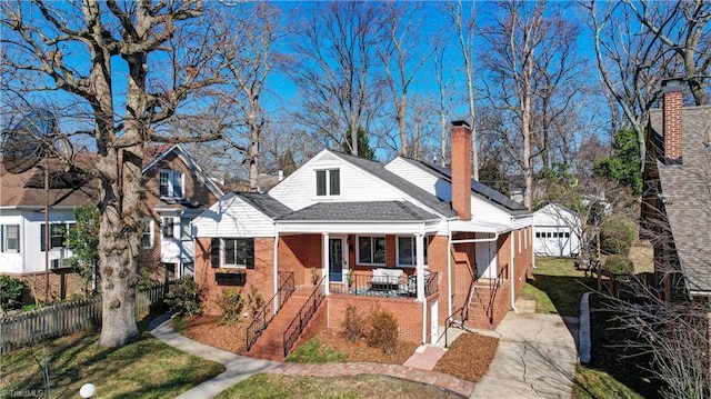 bungalow-style home featuring covered porch and a front yard