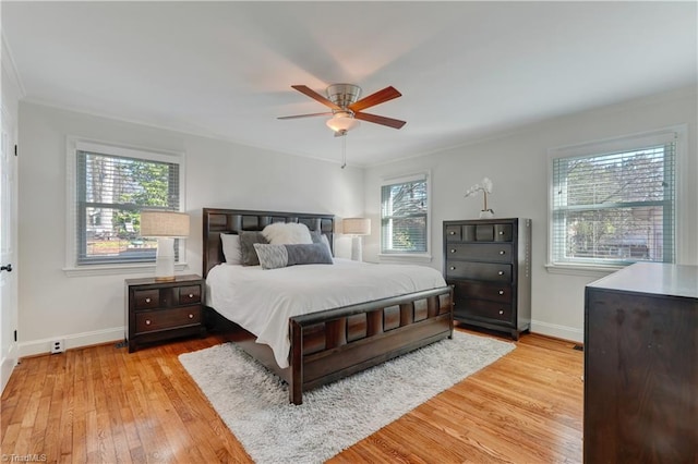 bedroom featuring ceiling fan, ornamental molding, and light hardwood / wood-style floors