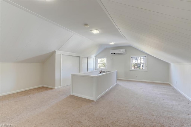 additional living space featuring vaulted ceiling, an AC wall unit, and light carpet