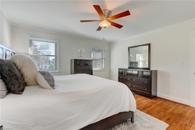 bedroom with ornamental molding, ceiling fan, and light wood-type flooring