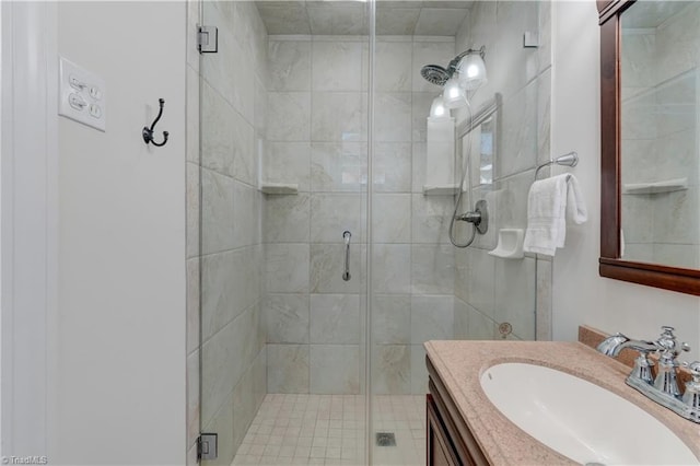 bathroom featuring vanity and an enclosed shower