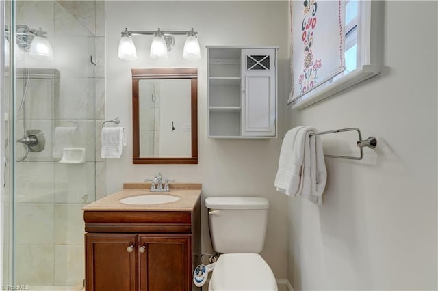 bathroom with an enclosed shower, vanity, and toilet