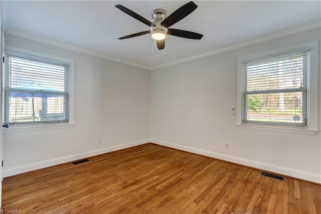 empty room featuring crown molding, wood-type flooring, and ceiling fan