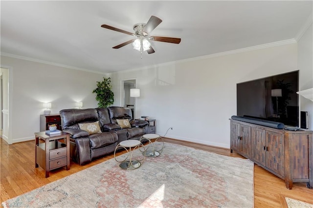 living room featuring ceiling fan, ornamental molding, and light hardwood / wood-style flooring