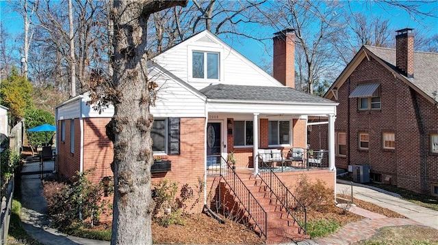 view of front facade featuring central AC and covered porch