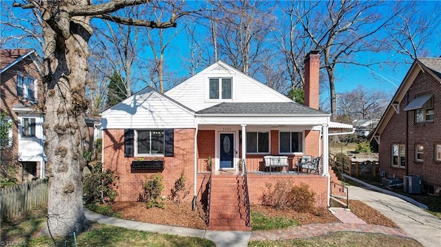 bungalow featuring cooling unit and a porch