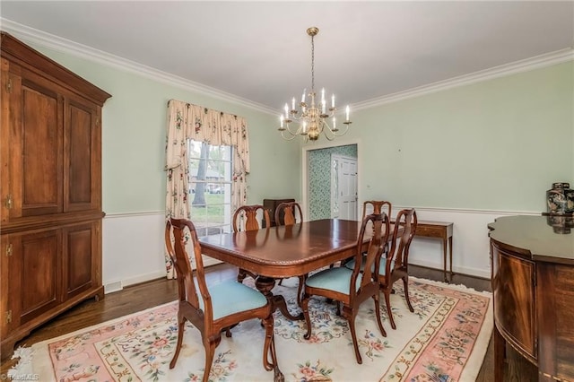 dining room with an inviting chandelier, crown molding, and dark wood-type flooring