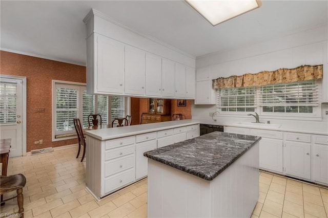 kitchen featuring sink, a kitchen island, black dishwasher, and light tile floors