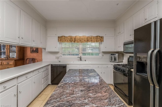 kitchen featuring white cabinetry, sink, black appliances, and crown molding