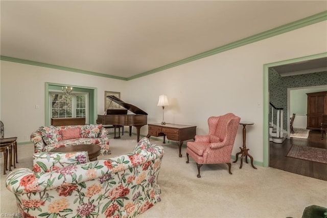 living room with an inviting chandelier, crown molding, and light hardwood / wood-style flooring