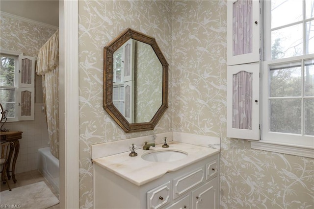 bathroom featuring shower / bath combo with shower curtain, crown molding, vanity, and tile walls