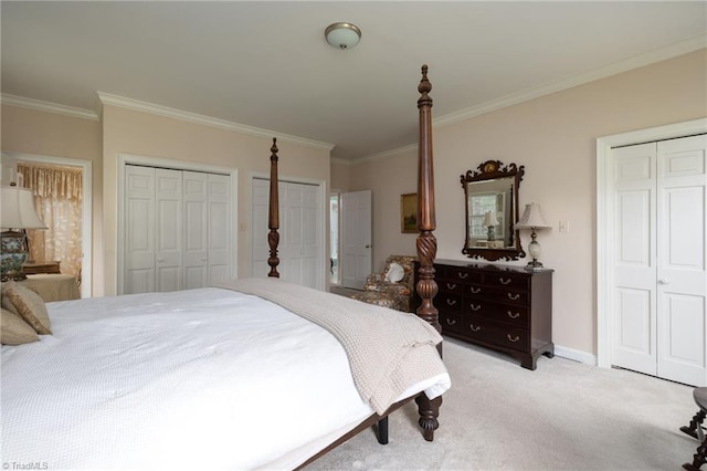 carpeted bedroom with crown molding and multiple closets