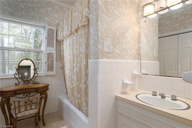 bathroom with shower / tub combo, tile floors, tile walls, and vanity