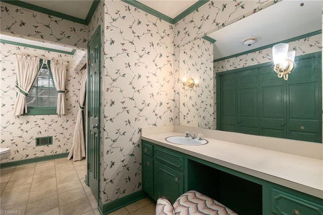 bathroom with tile flooring, crown molding, toilet, and large vanity