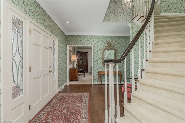 entryway featuring dark hardwood / wood-style flooring and ornamental molding