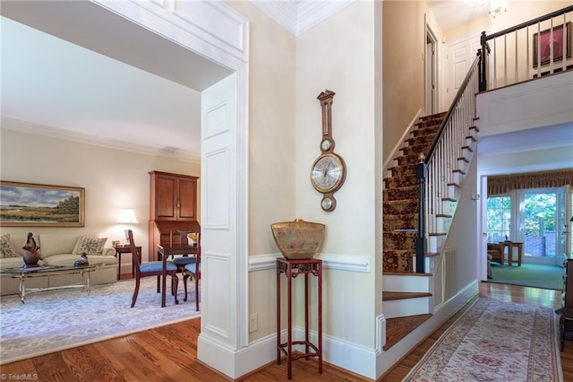 interior space featuring hardwood / wood-style flooring and ornamental molding