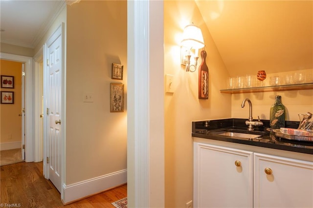 bathroom featuring hardwood / wood-style flooring, vanity, and crown molding