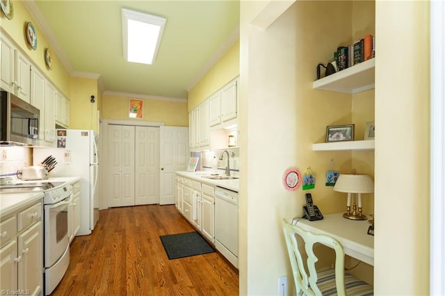 kitchen featuring white appliances, dark hardwood / wood-style floors, white cabinetry, and sink