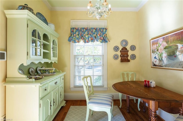 dining room featuring a chandelier, dark hardwood / wood-style floors, and ornamental molding