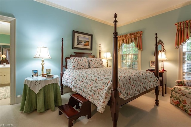 carpeted bedroom featuring connected bathroom and ornamental molding