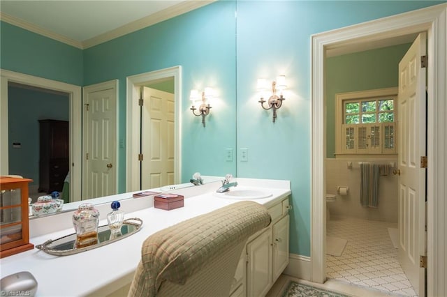 bathroom with tile patterned flooring, vanity, toilet, and crown molding