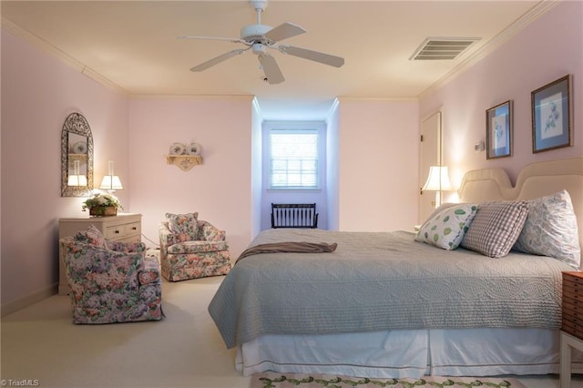 carpeted bedroom featuring ceiling fan and crown molding