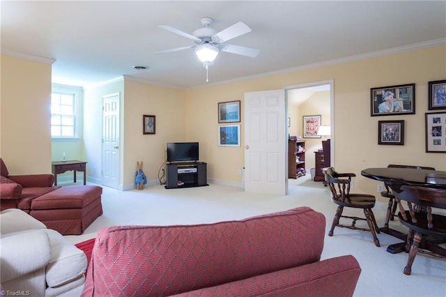 carpeted living room with ceiling fan and ornamental molding