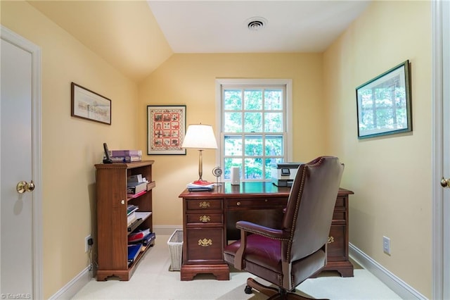 carpeted office with lofted ceiling