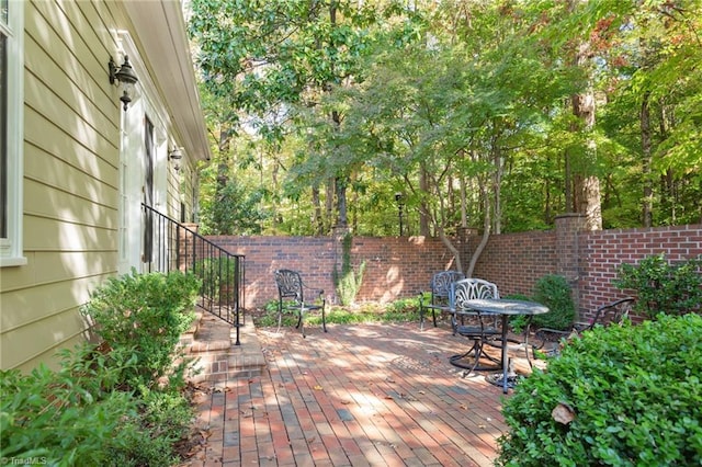 wooden terrace featuring a patio area