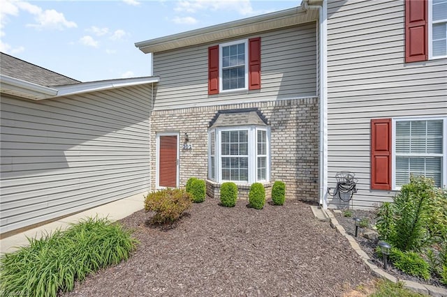 property entrance featuring brick siding