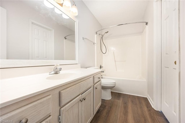 full bath with vanity, toilet, wood finished floors, and shower / washtub combination