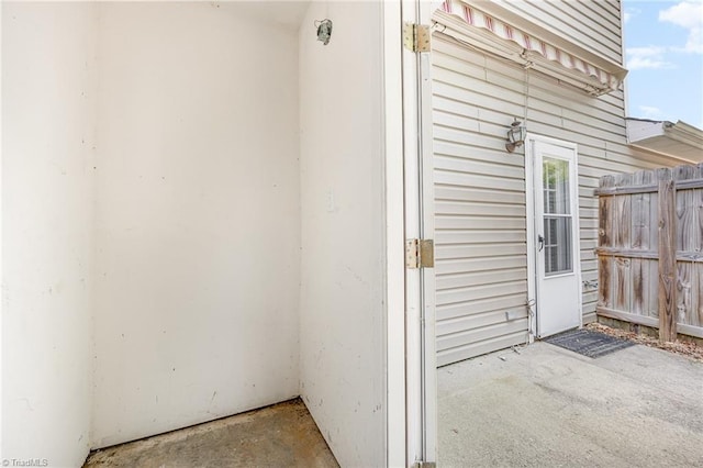 property entrance featuring a patio area and fence