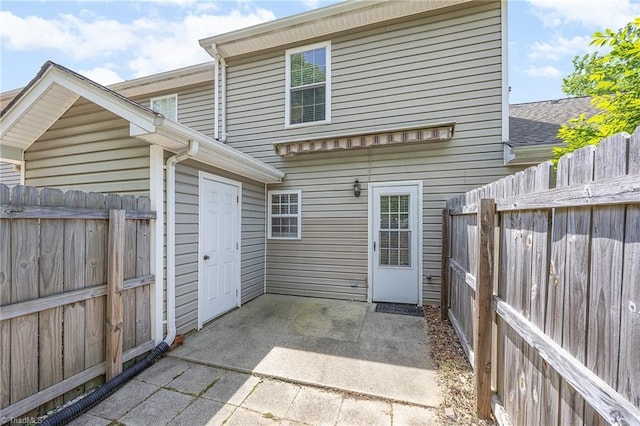 back of house featuring a patio and fence