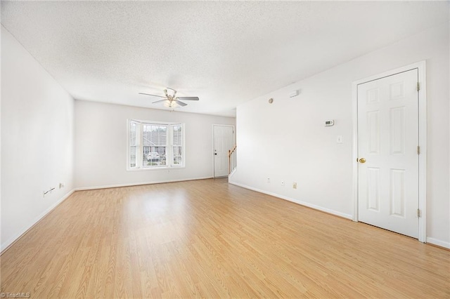 unfurnished living room with light wood-style floors, a textured ceiling, and ceiling fan