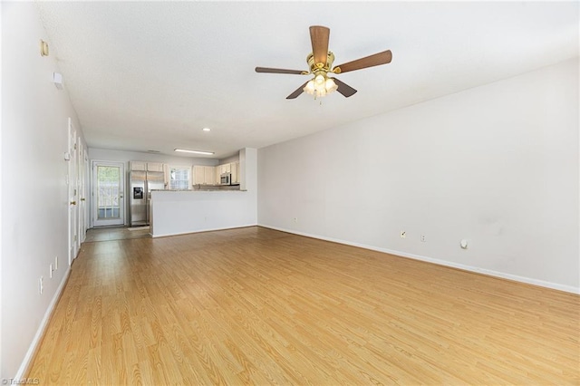 unfurnished living room with baseboards, light wood-style flooring, and ceiling fan