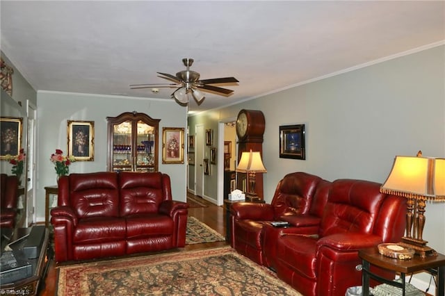 living room with wood-type flooring, ornamental molding, and ceiling fan