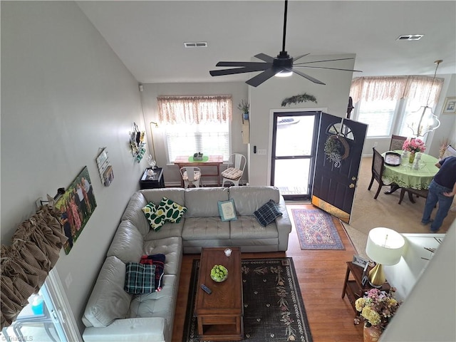 living room featuring ceiling fan and hardwood / wood-style flooring