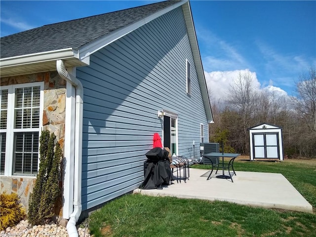 exterior space with a yard, a storage unit, and a patio