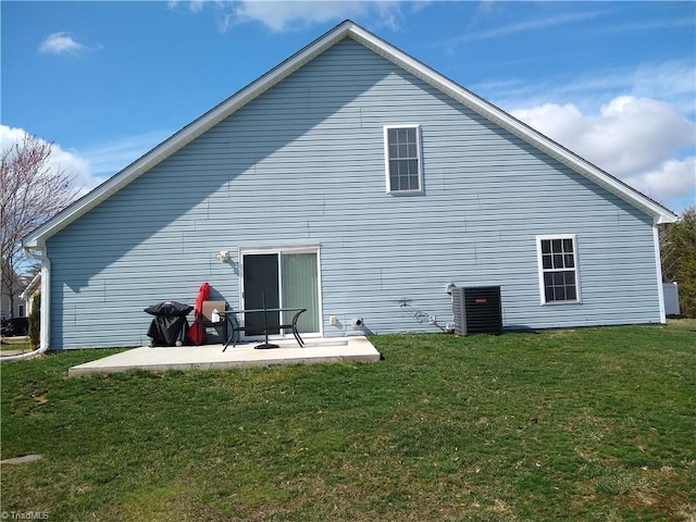 back of property featuring a patio area and a lawn